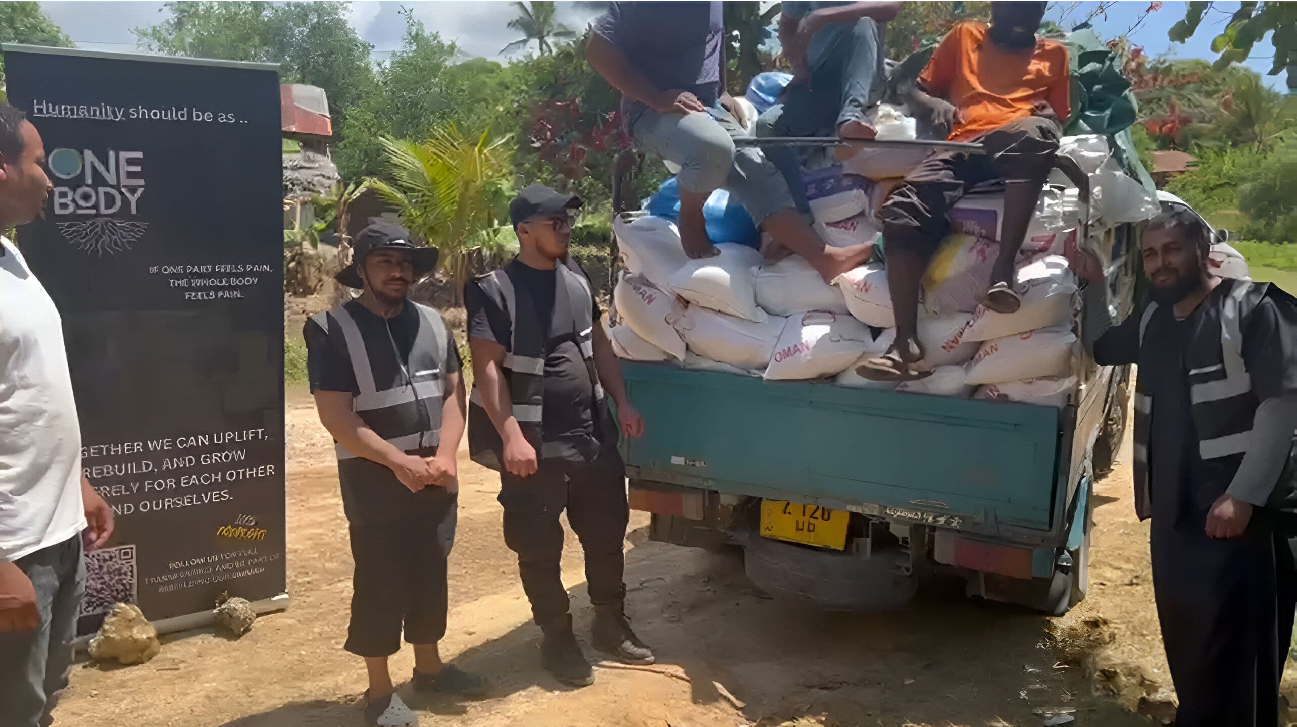 Lorry loaded with food pack with staff ready to distribute.